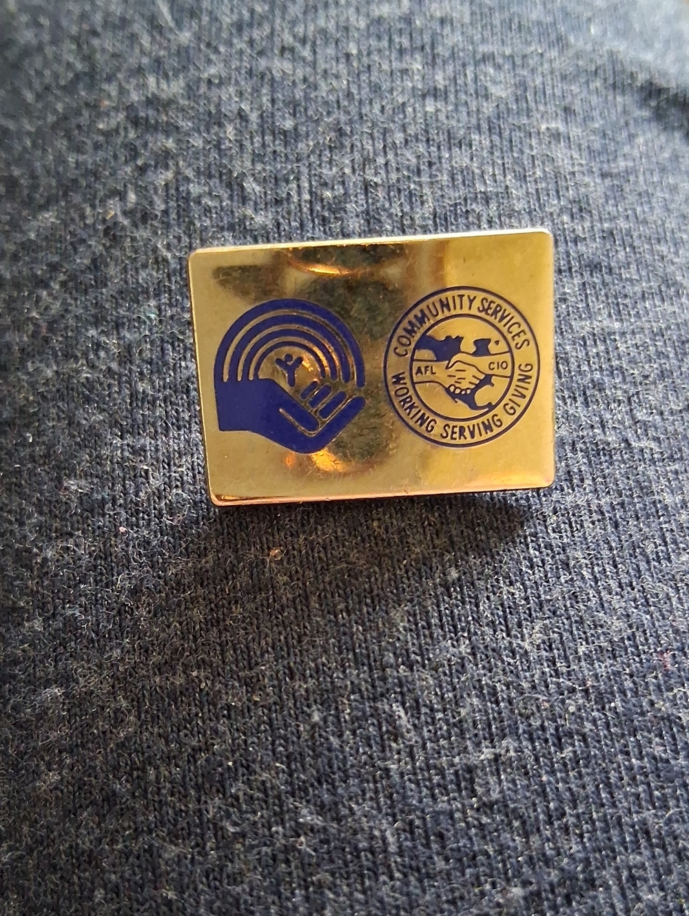 Community Services Gold Tone Pin with Blue Logo